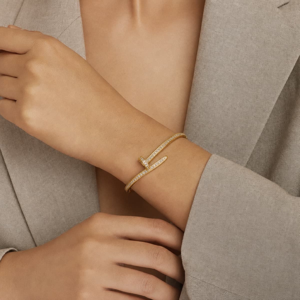 The Nail bracelet in gold worn on the wrist